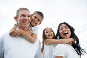 family in white smiling and happy about ancillary benefits